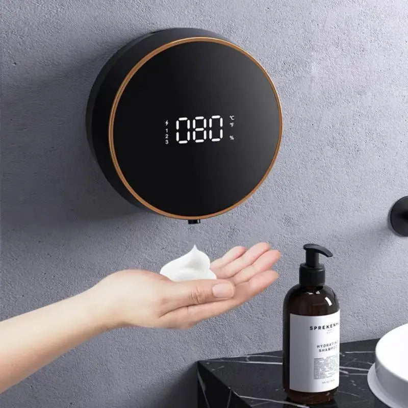 A black smart soap dispenser with a digital display, dispensing foam into a hand.