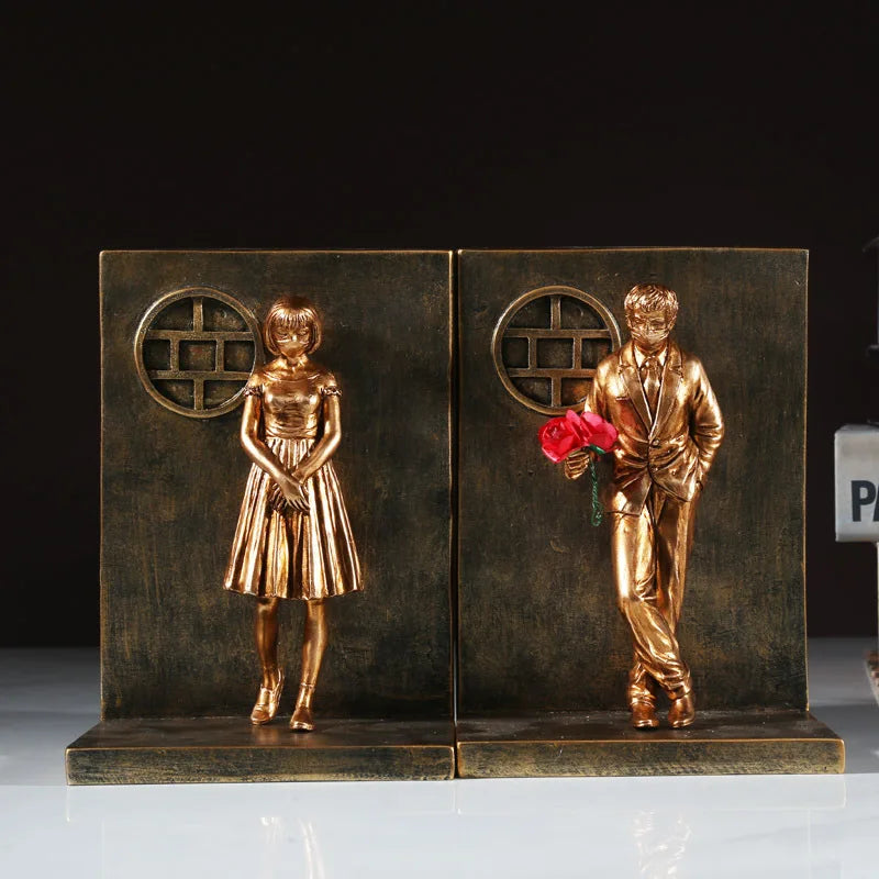 Bronze book stand with male and female figures.