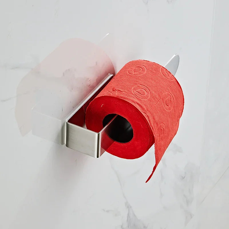 Silver adhesive towel ring holding red toilet paper roll.