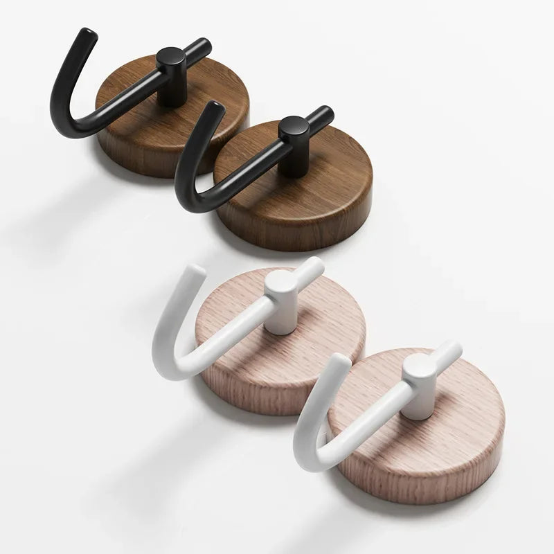 Sets of wooden coat hooks with black and white arms.