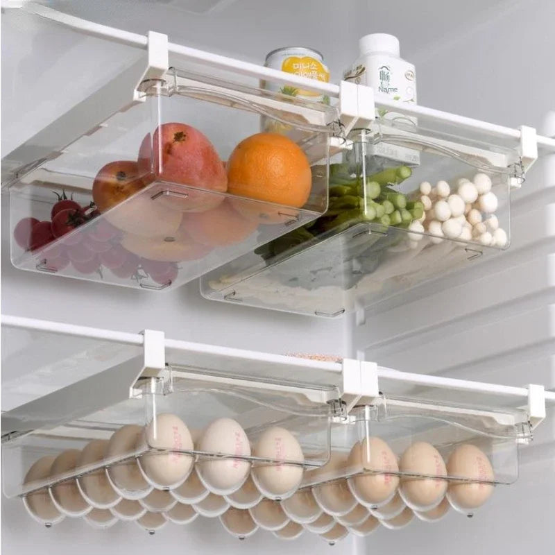 Transparent refrigerator drawers neatly storing fruits, eggs, and bottled items on fridge shelves.