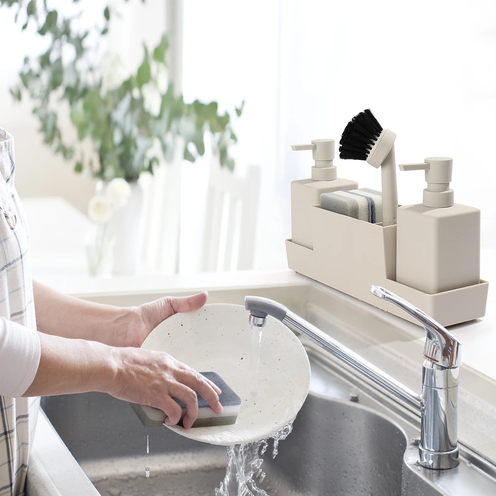 White sink caddy in use beside kitchen sink.