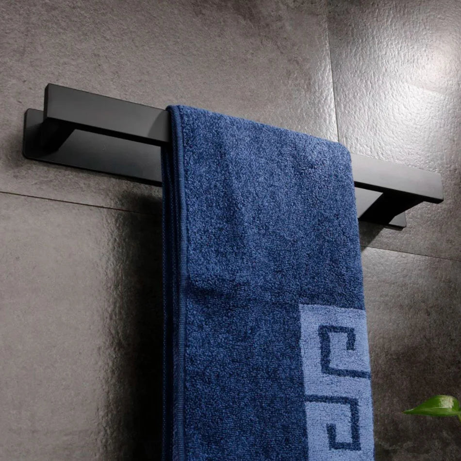 Matte black self adhesive towel rail with blue towel hanging.