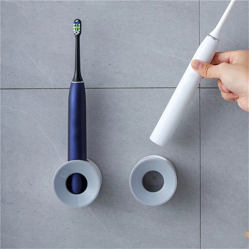 Two wall-mounted toothbrush holders side by side, one holding a toothbrush