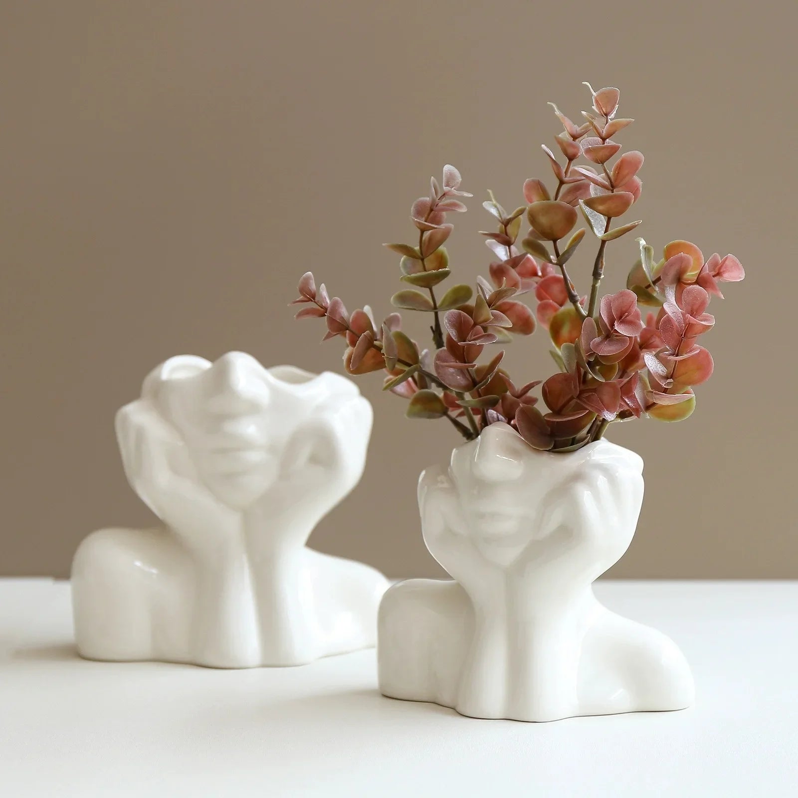White and black body shape vases styled with small flowers.