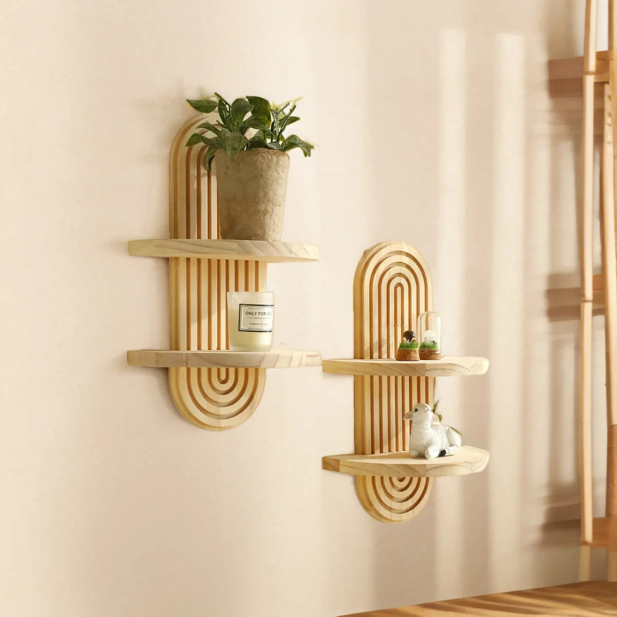 Two-tier boho shelves with mini vases and plants on a cream wall.