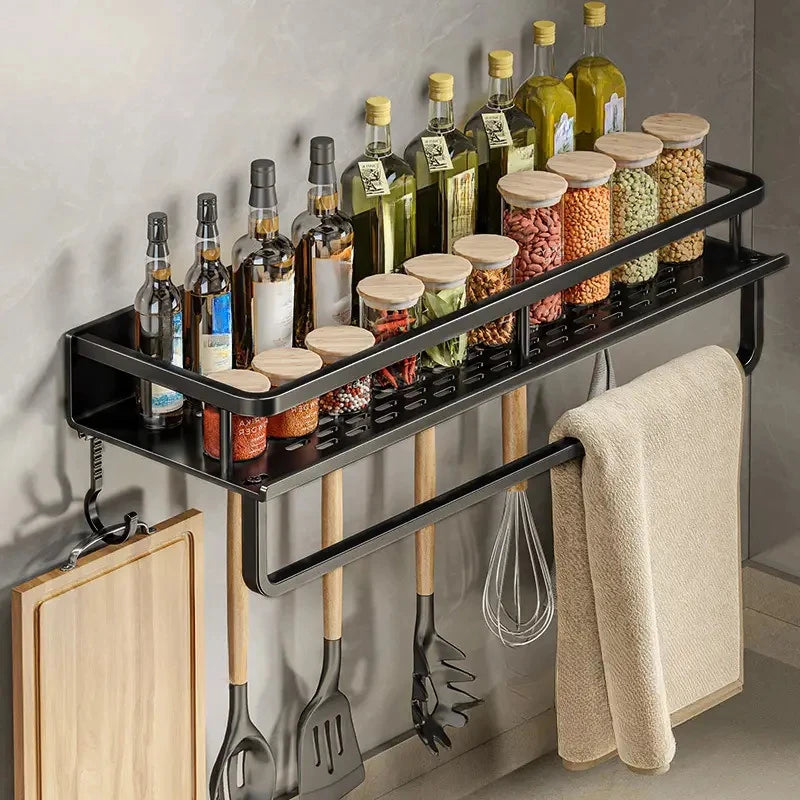 Wall-mounted black spice rack organizer holding oil bottles, spice jars