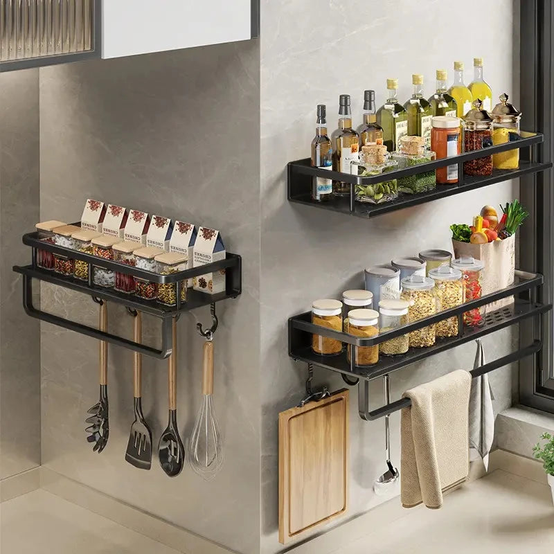 Multiple wall-mounted spice rack organizers storing condiments and kitchenware.