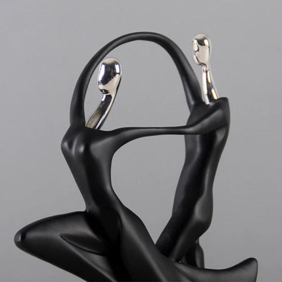 Close-up of black dancing figurine.