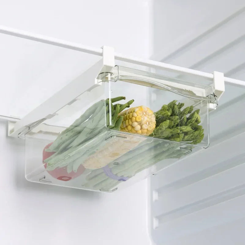 Refrigerator drawer holding corn and vegetables mounted under a fridge shelf.