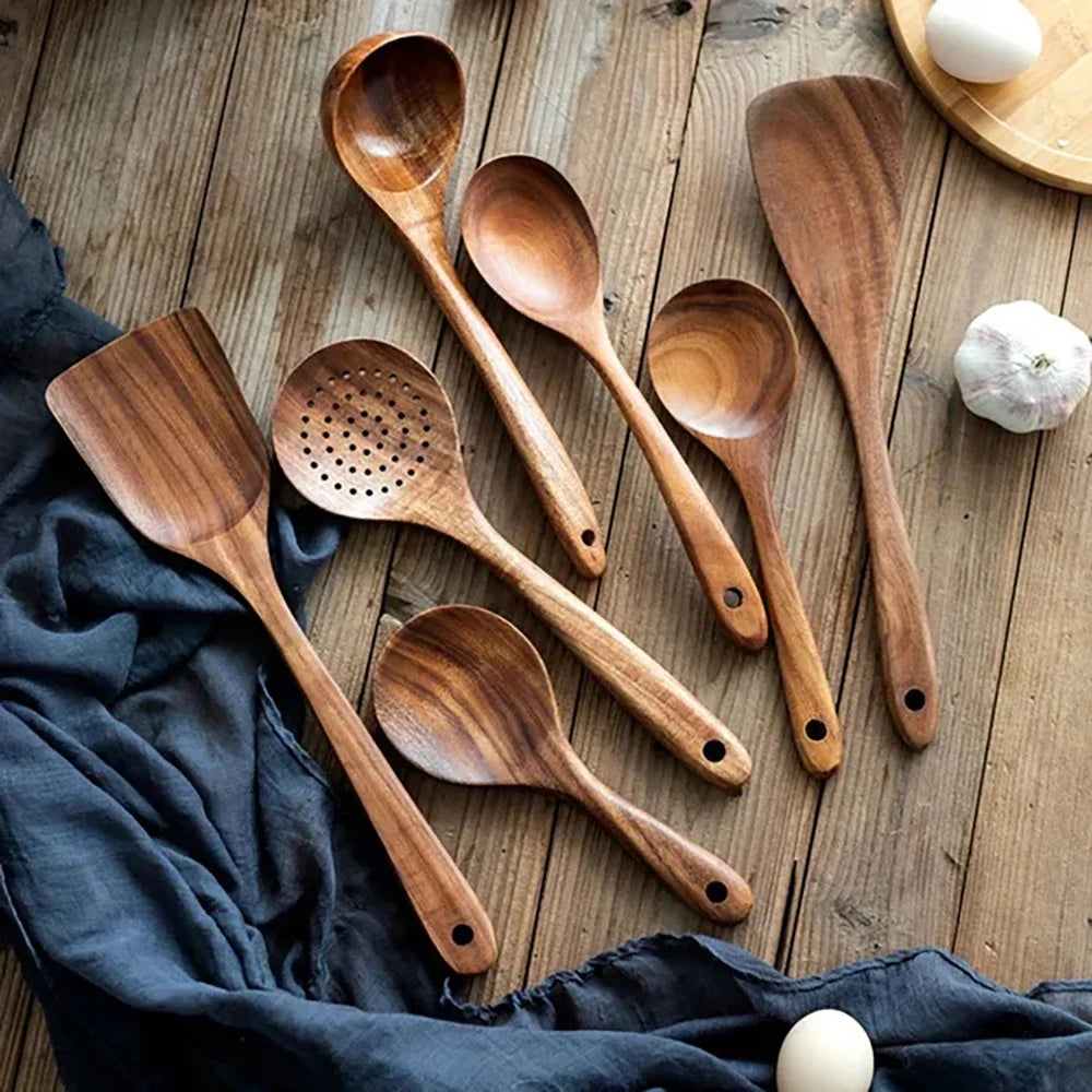 Wooden kitchenware set with eggs and garlic on a cloth.