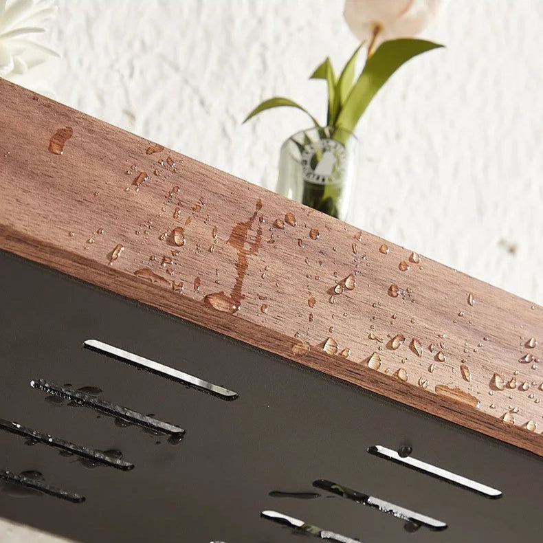 Close-up of a floating wood shelf with water droplets and a small vase.