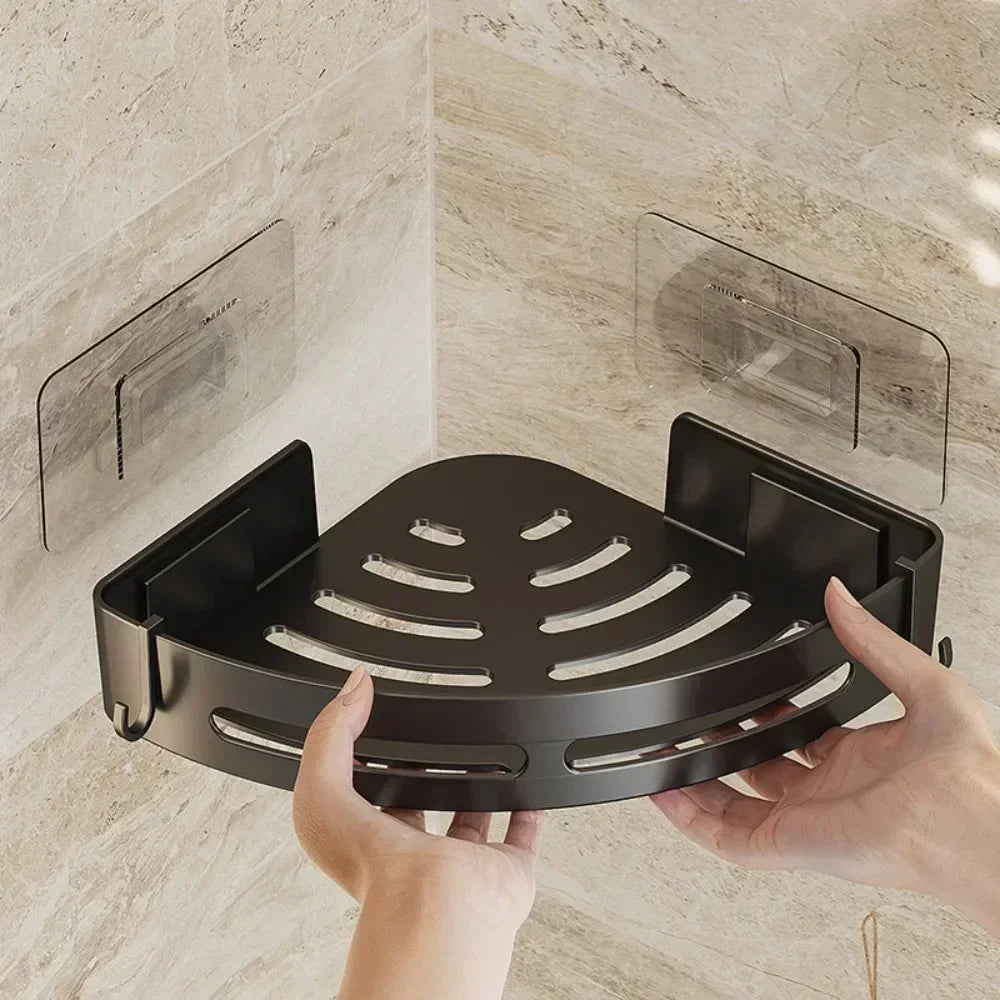 Installing black corner shower caddy on tile wall.