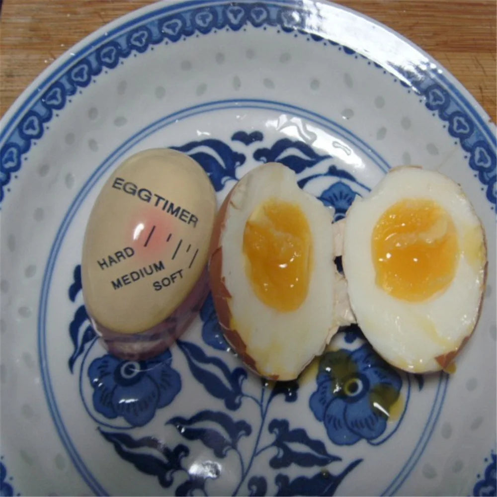 Egg timer on a plate with soft-boiled eggs.