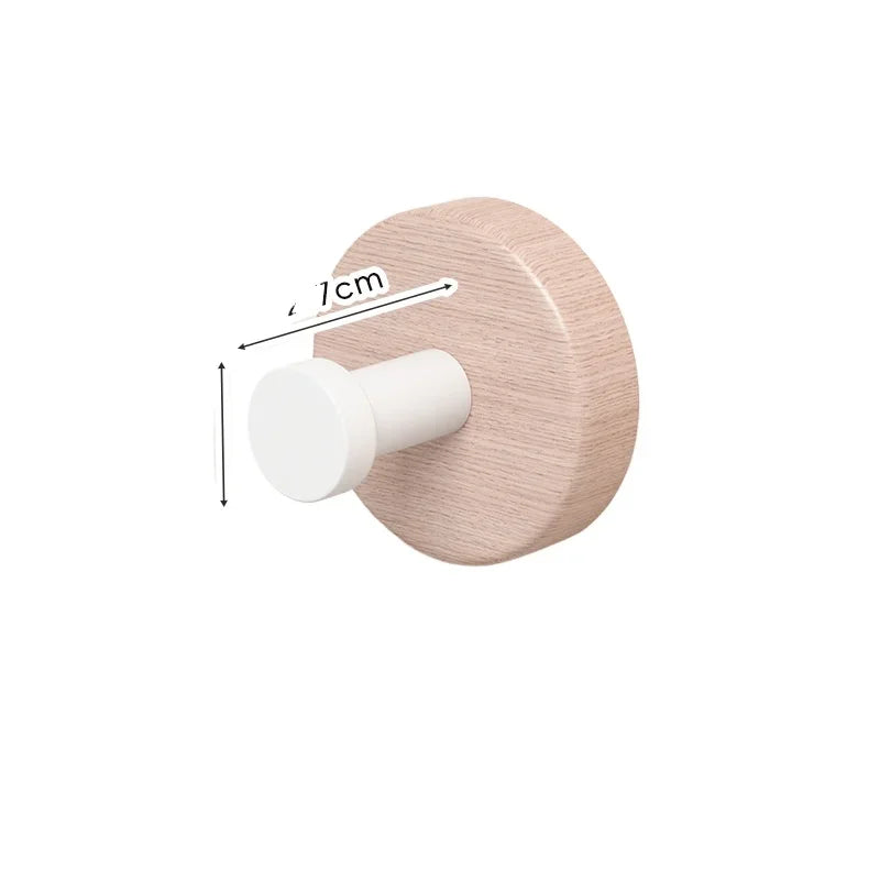 Wooden coat hook with a white arm, showing installation.