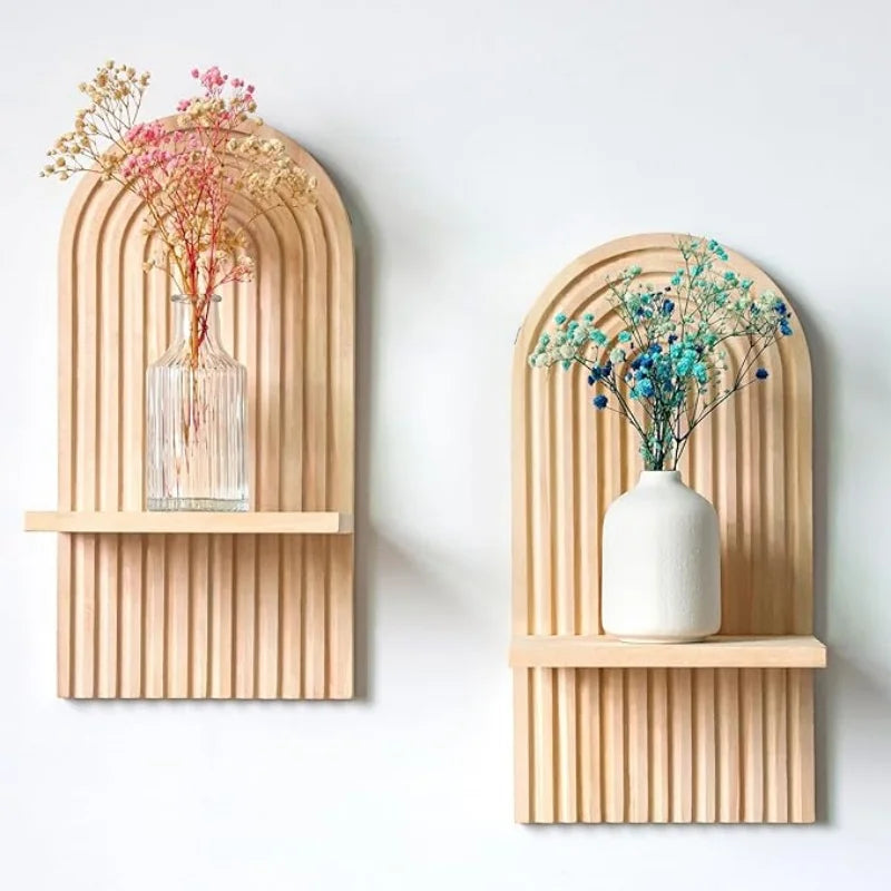 Set of two boho shelves with arch design, holding small vases with flowers.