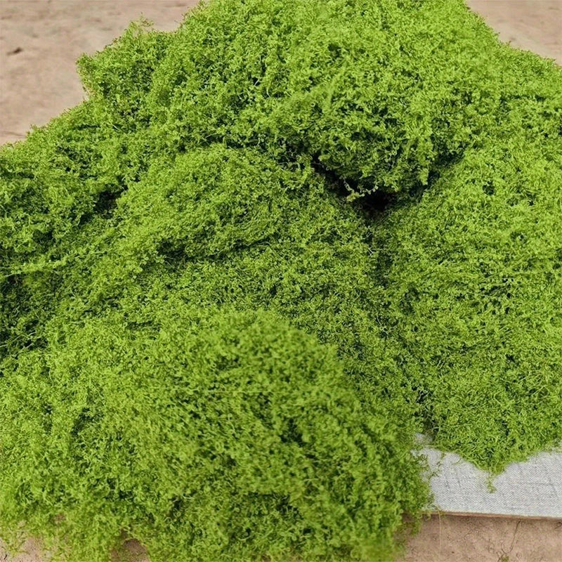 A pile of vibrant green fake moss placed on a table.