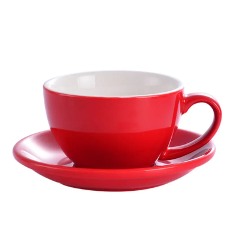 A red ceramic mug with a white interior and matching saucer.