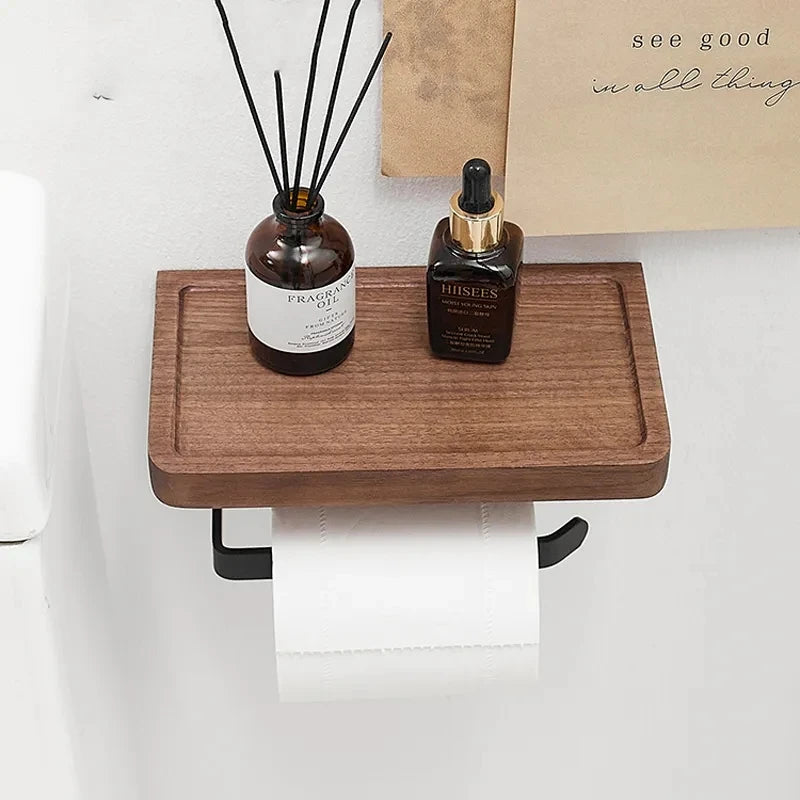 A wooden toilet paper holder with a short, black metal arm.