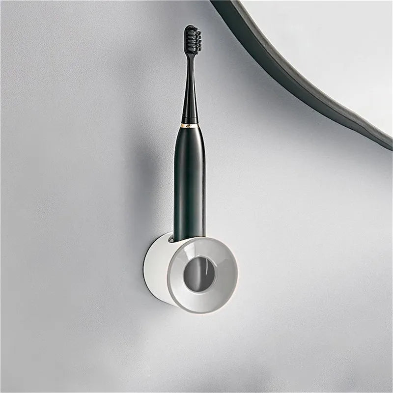 Toothbrush holder with white circular top mounted on wall holding toothbrush