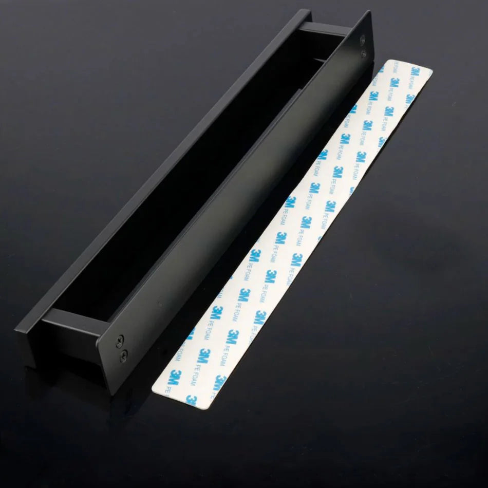 Black self adhesive towel rail with adhesive strip beside it.