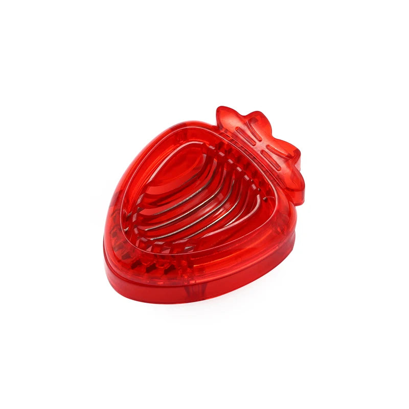 A closed red, heart-shaped strawberry slicer.