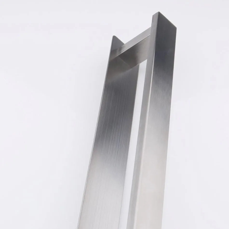 Tall stainless steel self adhesive towel rail standing upright.