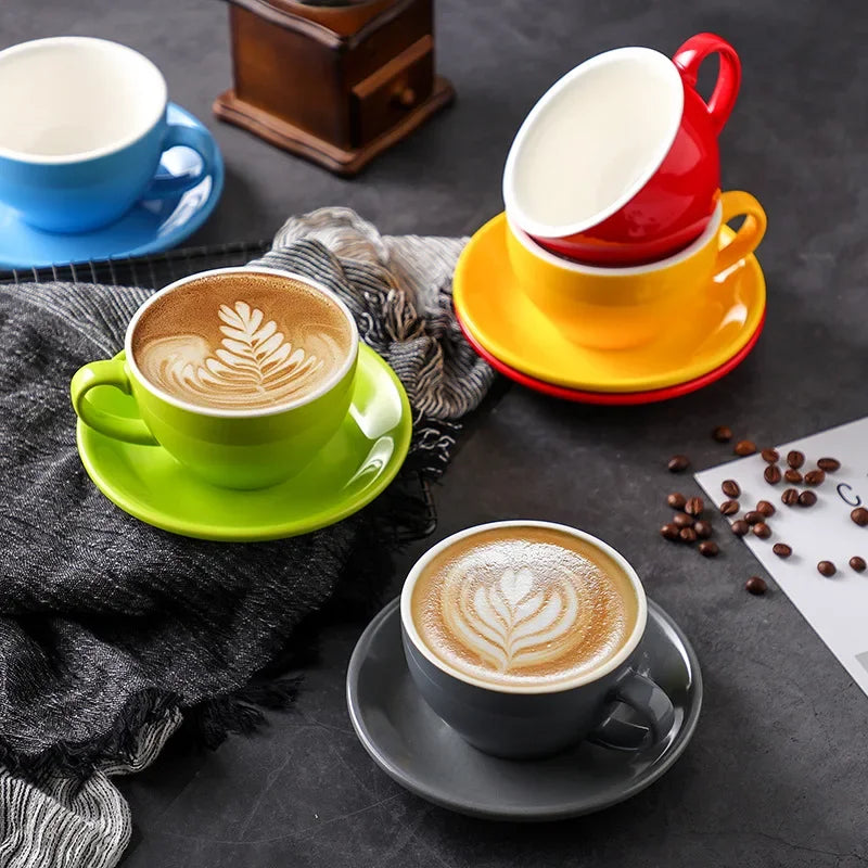 Colorful ceramic mugs and saucers with coffee, some stacked.