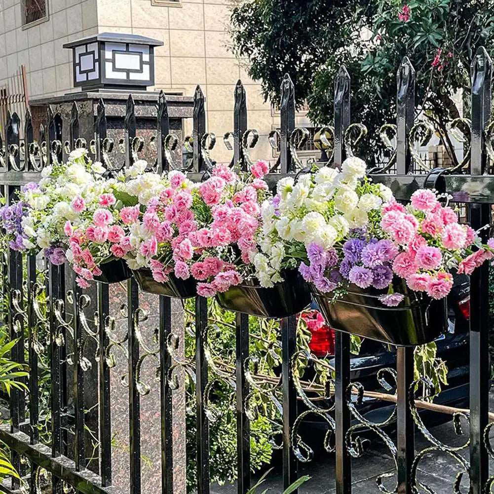 Hanging flower pots filled with colorful flowers on a black fence.