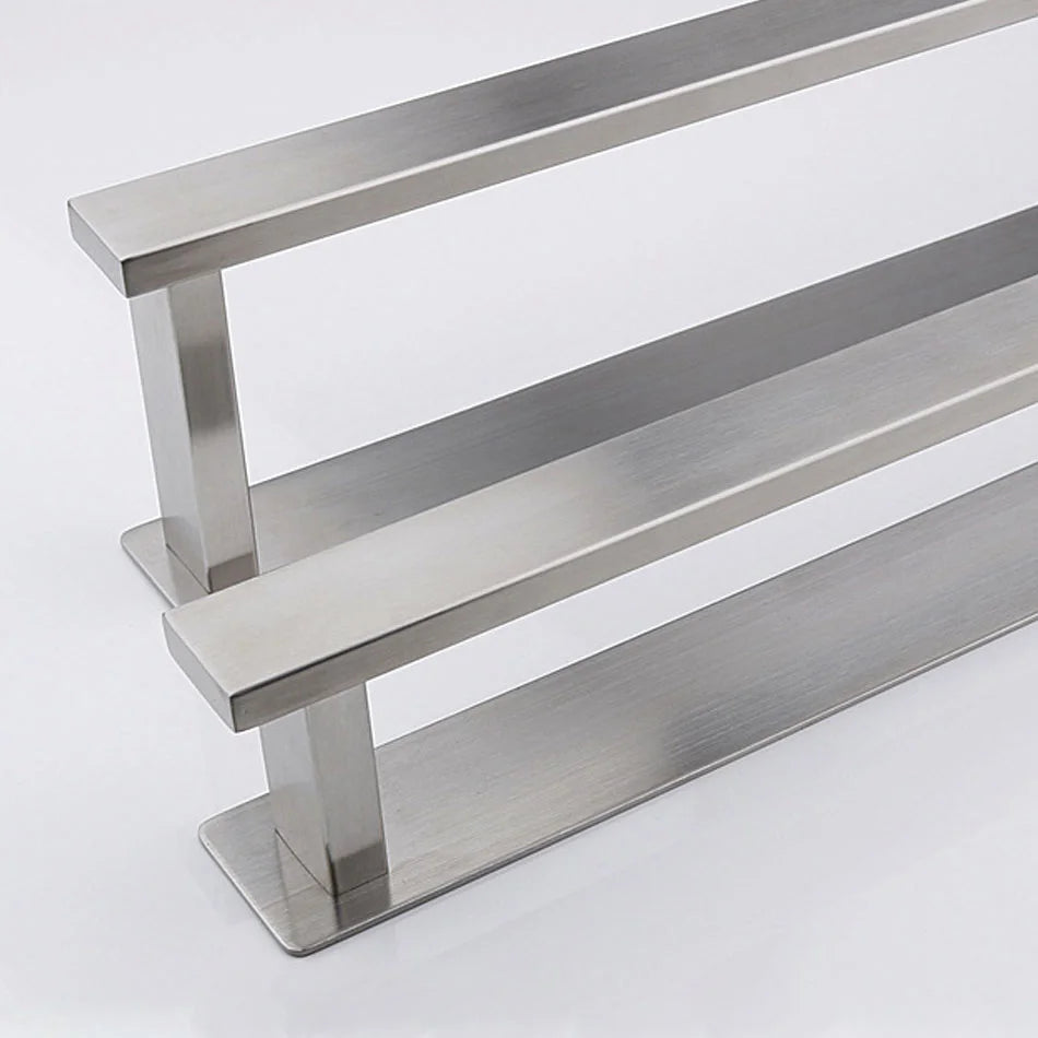 Brushed steel self adhesive towel rail with double bar design on white background.
