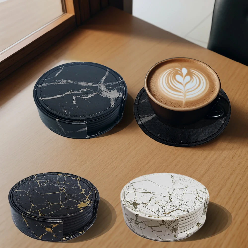 Set of round marble-patterned drink coasters in black, gold, and white