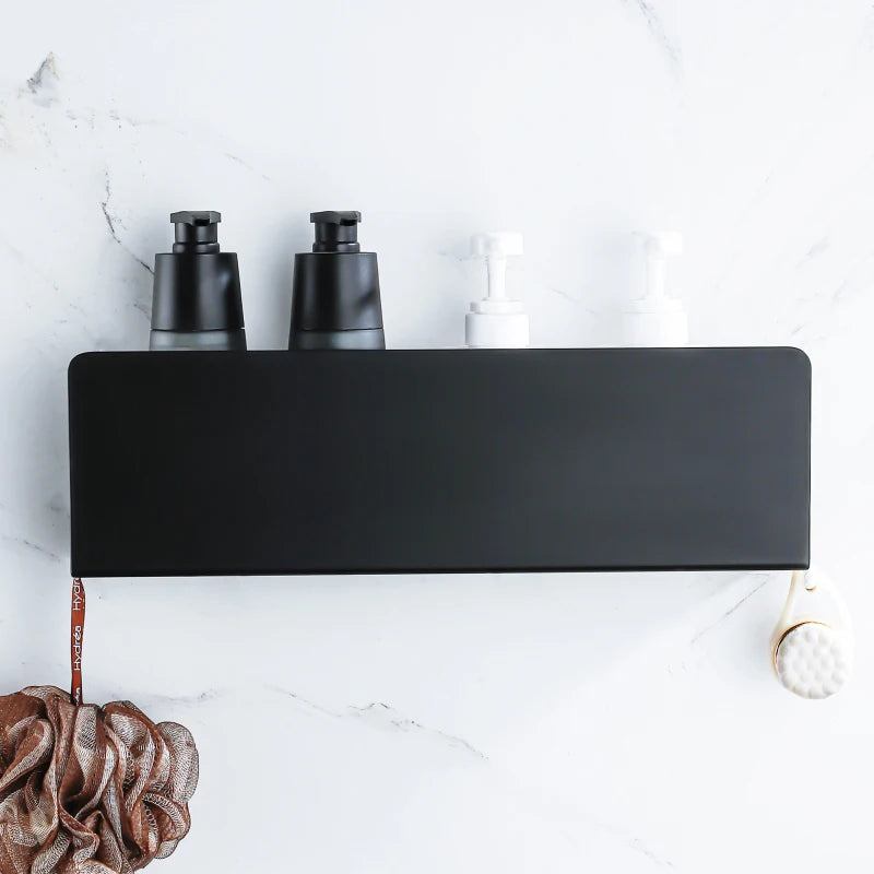 Wall-mounted black bathroom organizer with bottles and hanging accessories.