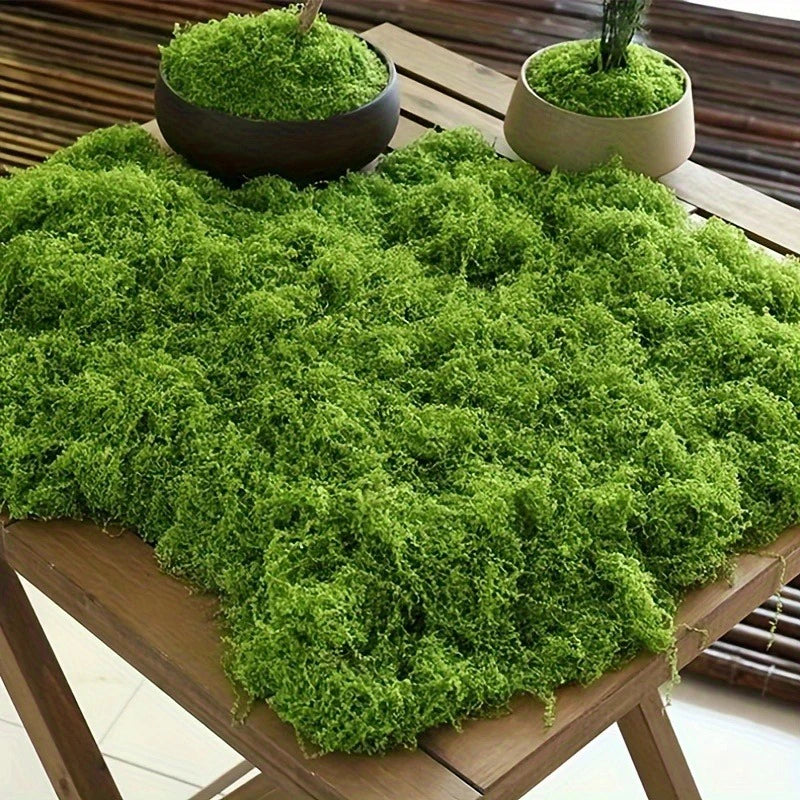 Various fake moss pieces displayed in pots and on tabletops.