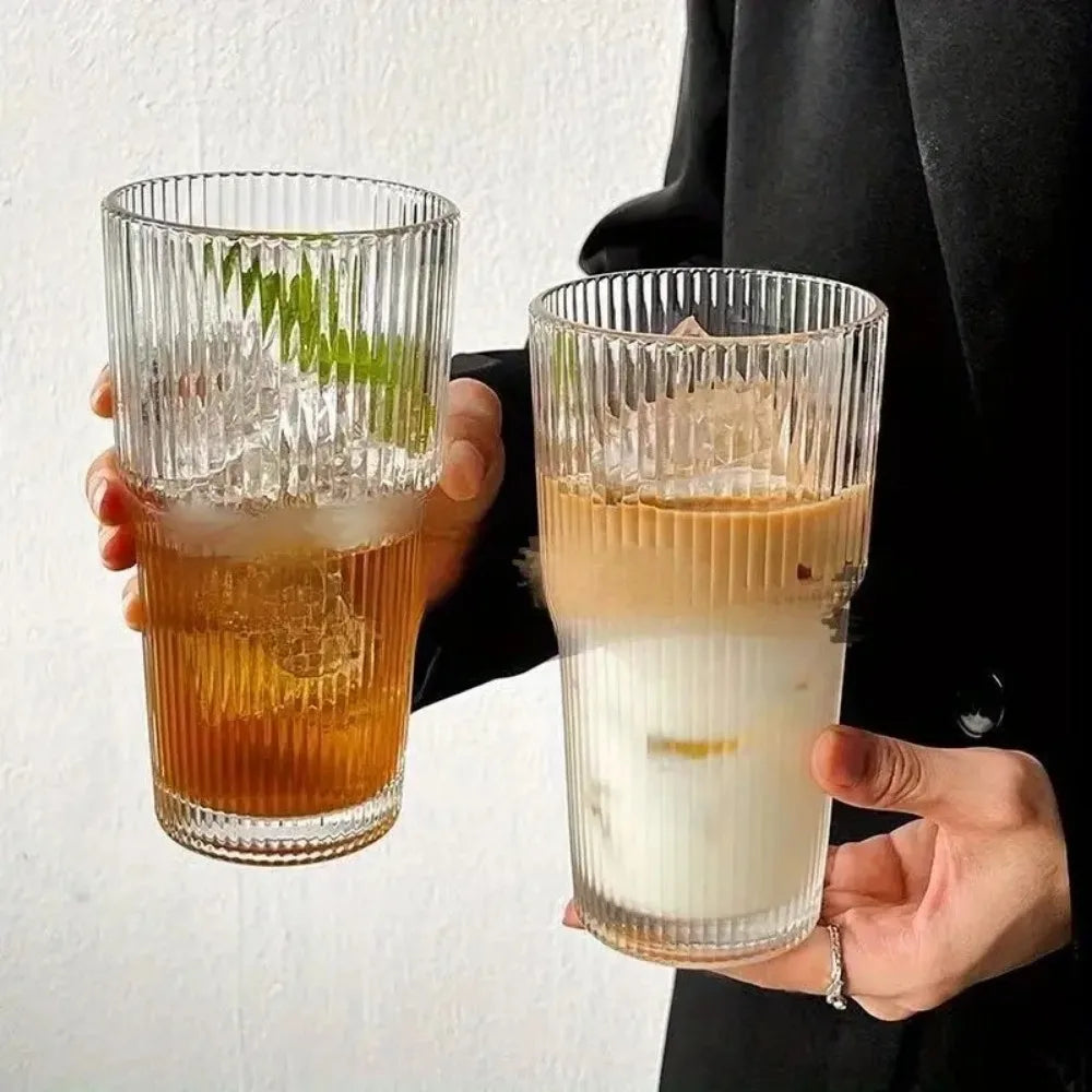 Iced drinks in ribbed glass cups with lids.