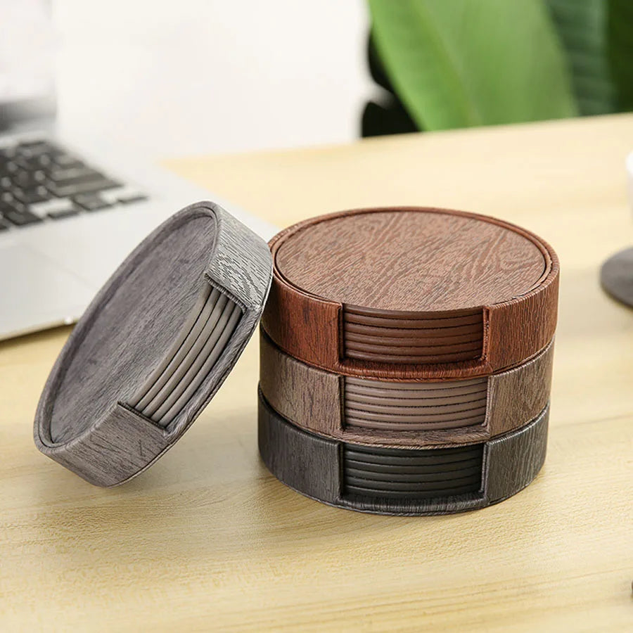 Round coasters tea set in gray, brown, and black with holders.