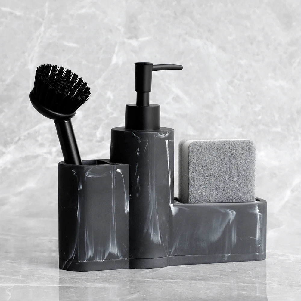 Black marble dish soap dispenser with sponge and brush holder.