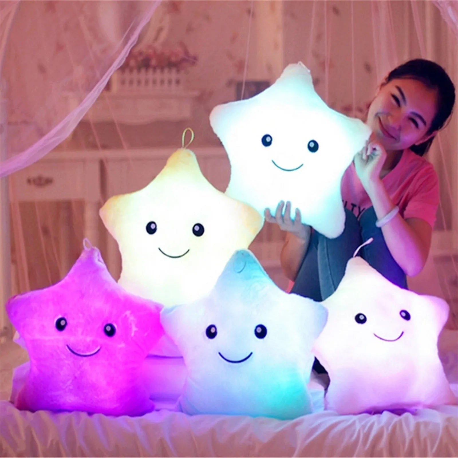 Smiling girl with glowing star-shaped pillows.